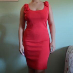 Coral dress with floral accents.
